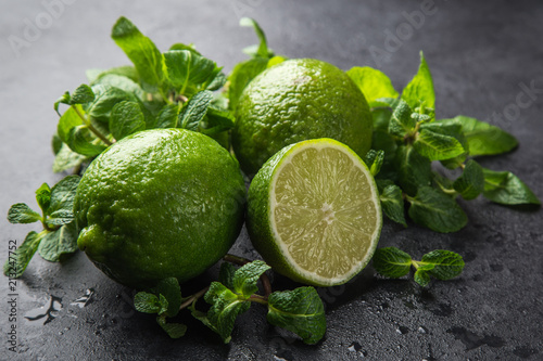 fresh green lime and mint on black background,