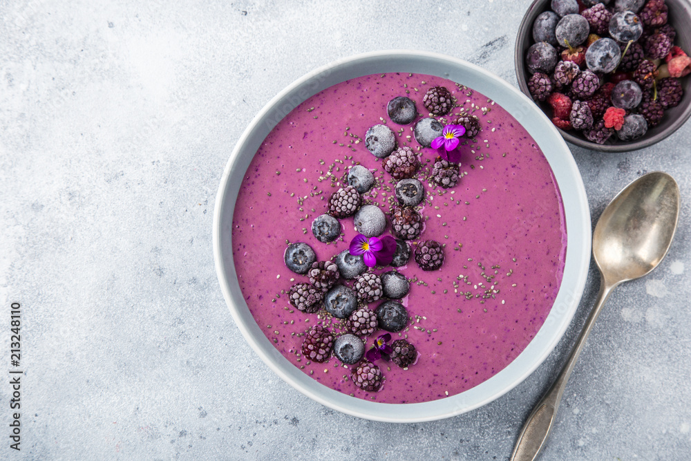 delicious blueberry smoothie bowl with frozen berries - obrazy, fototapety, plakaty 
