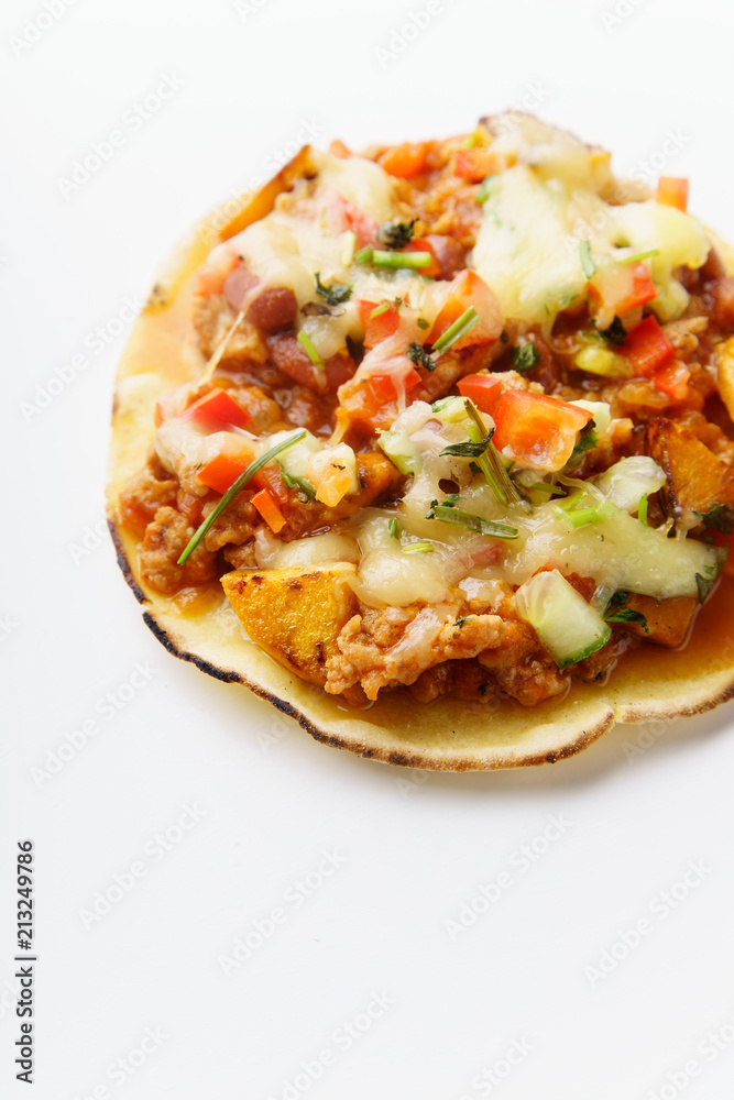 Close up of mexican taco with chili con carne, grilled sweet potatoes and grated cheese on white background. Text space