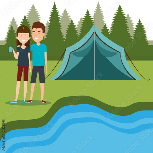 couple with smartphones in the camping zone