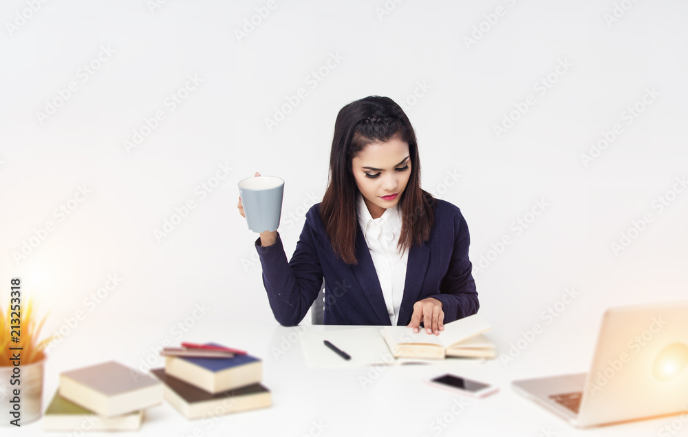 The business woman is working at office hour by laptop, mobile phone, and paperwork
