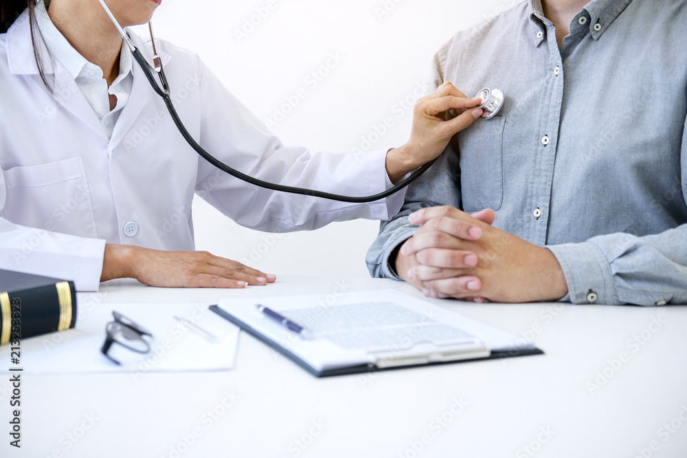 Female doctor checking heart beat of patient and recommend treatment methods and how to use medicine Female doctor checking heart beat of patient and recommend treatment methods and how to use medicine
