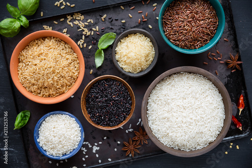 Fototapeta Variety of rice - red rice, black rice, basmati, whole grain rice, long grain parboiled rice and arborio rice - in bowls