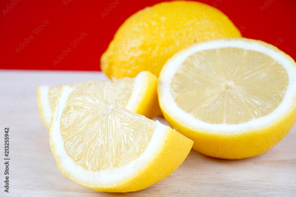 Lemon slices over red background. Space for text. Selective focus Lemon slices over red background. Space for text. Selective focus