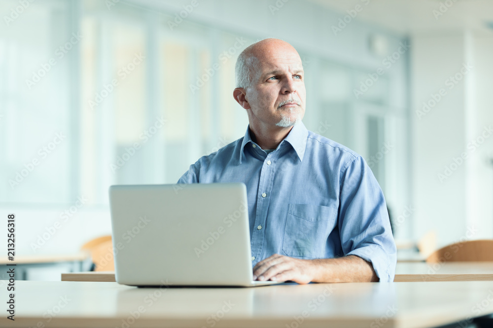 man seated in front of laptop computer man seated in front of laptop computer
