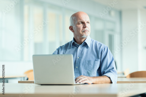 man seated in front of laptop computer