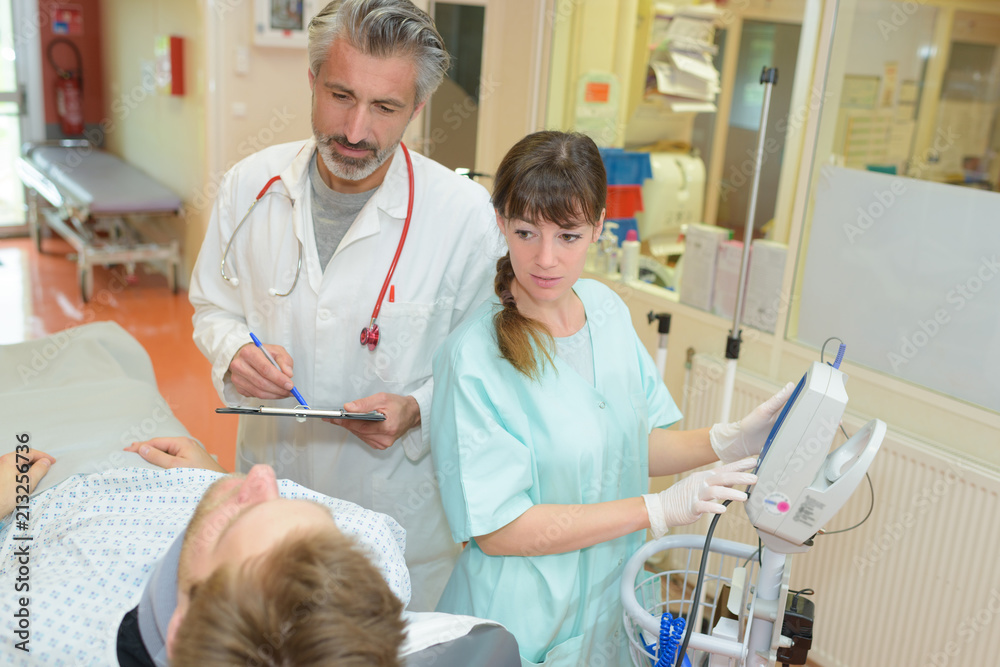 doctor and nurse telling patient the diagnosis doctor and nurse telling patient the diagnosis