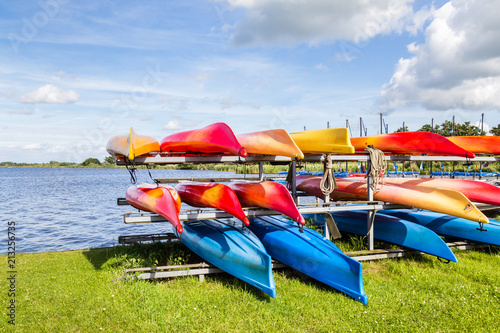 Water landscape with colorful rental canoes in the harbor of  a lake called Leekstermeer in Drenthe in the Netherlands photo