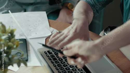 Female hand pointing at laptop screen discussion process male hands use laptop modern start up office desk with devices creative business team meeting brainstorming using digital display technology