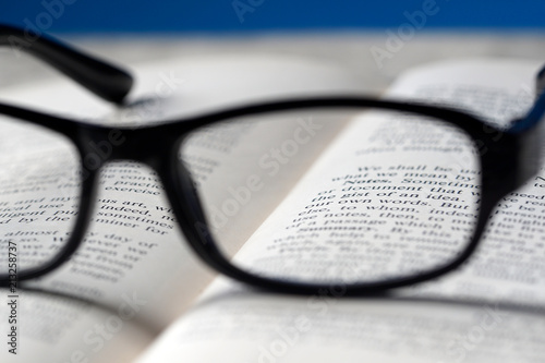 An eyeglasses and a book