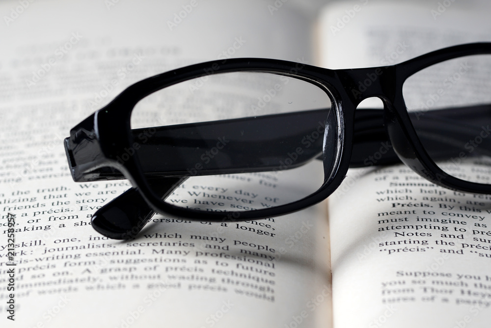 An eyeglasses and a book