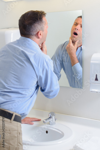 man looking in mirror