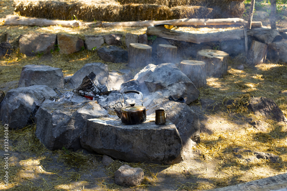 Cooking coffee on a fire. Make coffee or tea on the fire of nature. Burned fire. Place for the fire. Ash and coals and ash from the fire. Cooking coffee on a fire. Make coffee or tea on the fire of nature. Burned fire. Place for the fire. Ash and coals and ash from the fire.