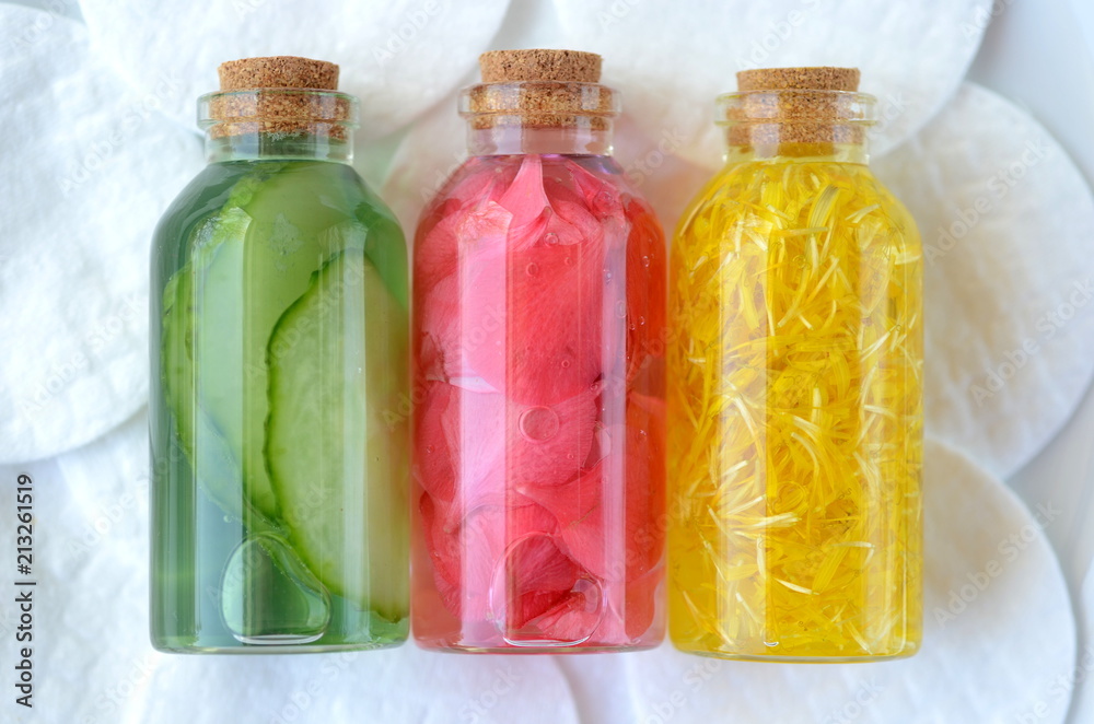 Three glass vial bottles of fresh natural plant based skin care facial toners with copy space. Organic herbal, plant and flower infusions for face and body. Cucumber, marigold and rose.
Three glass vial bottles of fresh natural plant based skin care facial toners with copy space. Organic herbal, plant and flower infusions for face and body. Cucumber, marigold and rose.