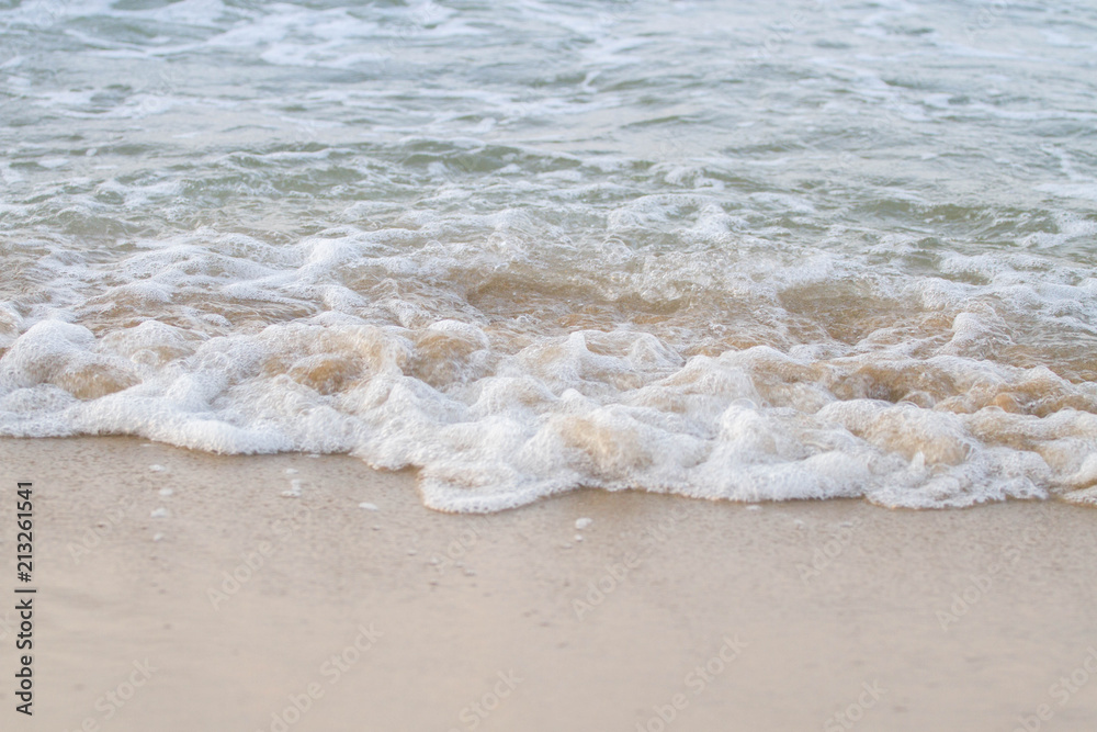 The sea waves on the beach in the morning, the sun is not soft focus The sea waves on the beach in the morning, the sun is not soft focus