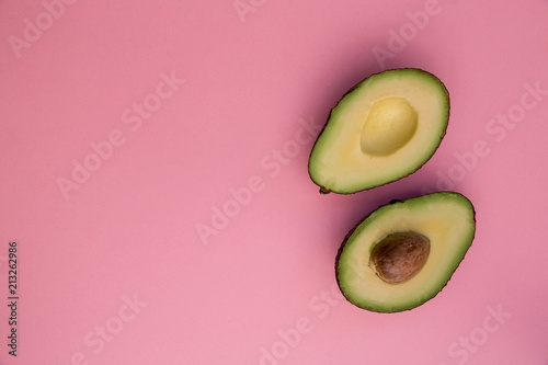 Avocado half on pink background minimal food