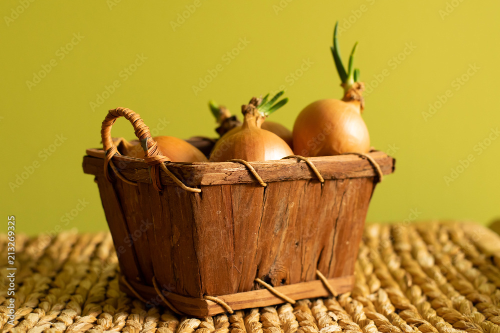 Onions in a small basket of brown colour.