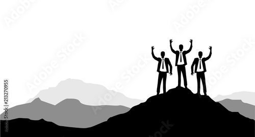 Businessmen raising their hands on a mountain peak. Victory concept.