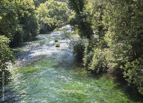 The romantic river Sorgue in Fontaine de Vaucluse. Vaucluse, Provence, France, Europe