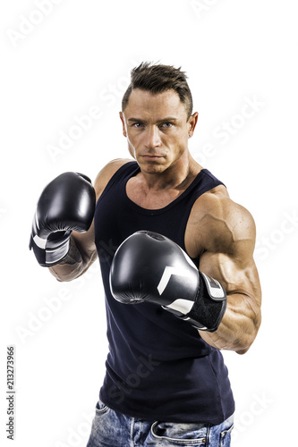 Attractive young man with boxer's gloves throwing a punch towards the camera