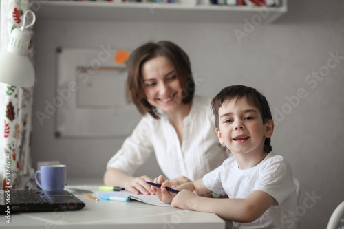 beautiful woman tutor study with child at home
