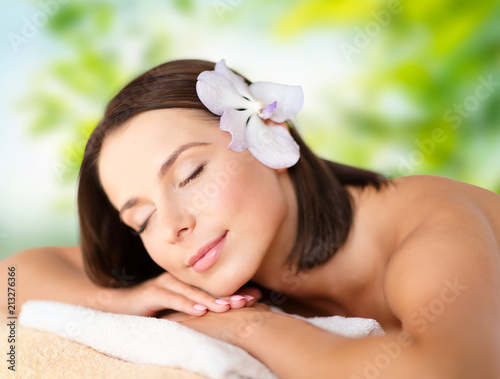 wellness, spa and beauty concept - close up of beautiful woman over green natural background