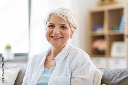 emotion, age and people concept - portrait of happy senior woman laughing