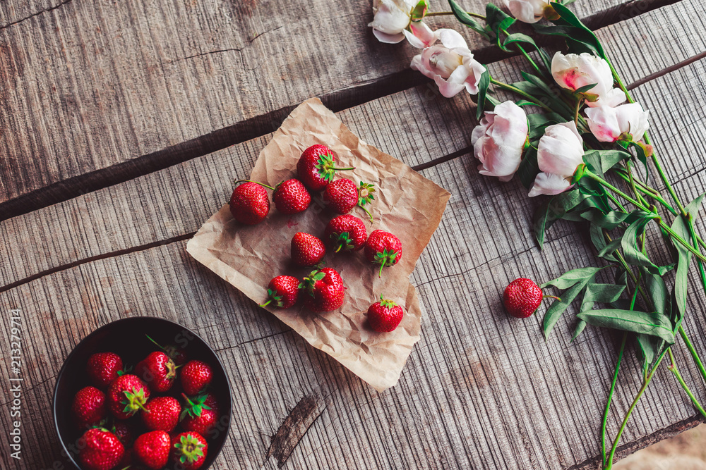 Breakfast with strawberries and flowers on the rustic table. Healthy breakfast, Clean eating, vegan food concept. Top view. Breakfast with strawberries and flowers on the rustic table. Healthy breakfast, Clean eating, vegan food concept. Top view.