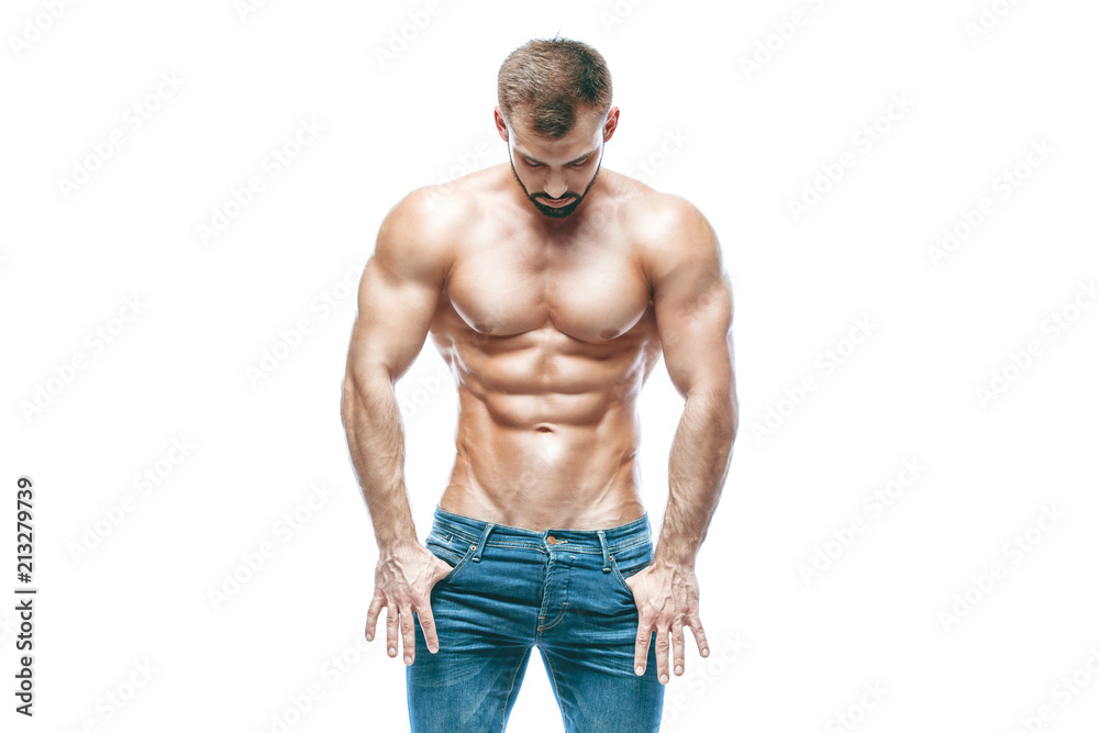 bodybuilder posing. Beautiful sporty guy male power. Fitness muscled in blue jeans. on isolated white background.