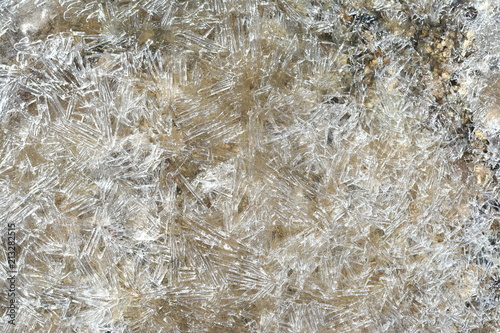 Ice Crystals on frozen pond. Close-up Ice pattern in puddle. Winter background