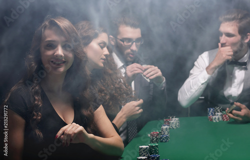 modern business woman sitting at craps table in a casino.