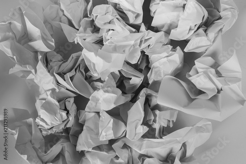 Black and white crumbled pieces of paper textured background  photo