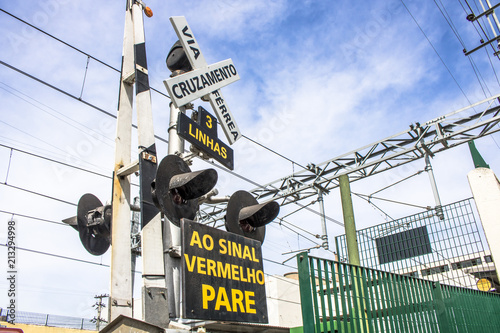 Level crossing between the street and railroad with traffic light and write 