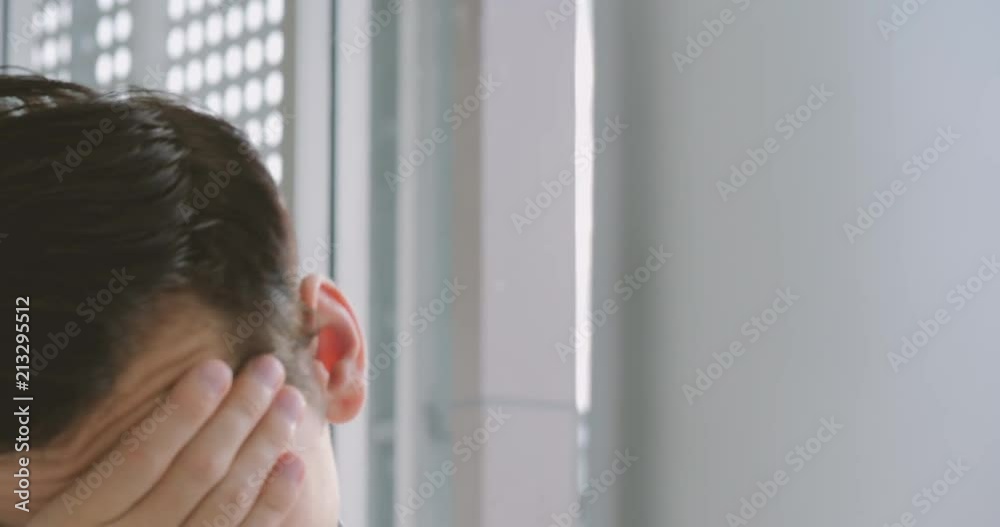 Tired and stressed businessman looking at the monitor of a personal computer, working in a home office. Tired and stressed businessman looking at the monitor of a personal computer, working in a home office.