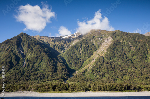 Mountain region with minimal snow and clouds on the south island of New Zealand photo