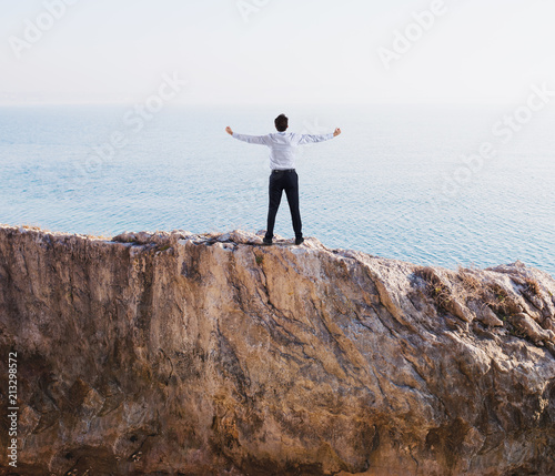 Freedom successful businessman over a high mountain