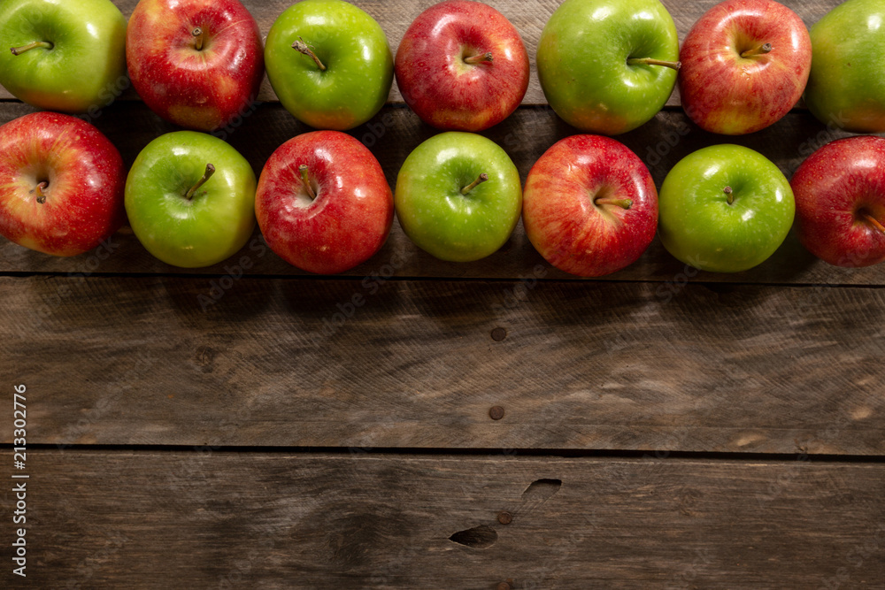 Apples red and green on rustic wooden table in basket Apples red and green on rustic wooden table in basket