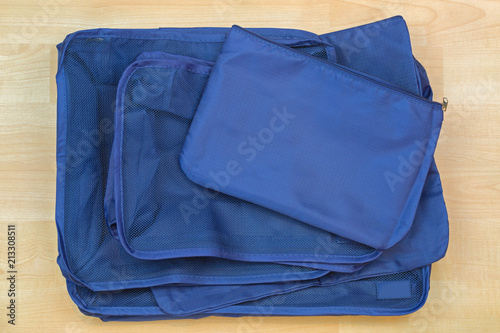 Different blue cube bags, set of travel organizer to help packing luggage easy