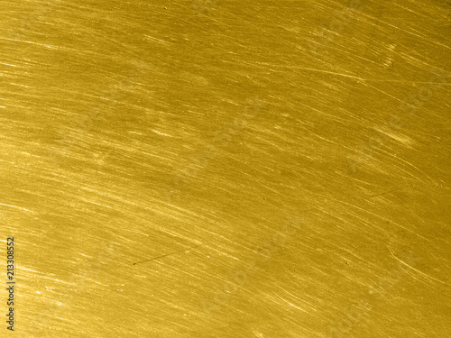 Gold metal texture with circular scratches.
