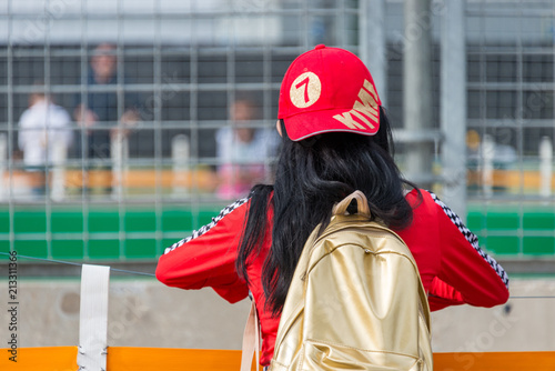 A motor sport racing fan along the side of the track