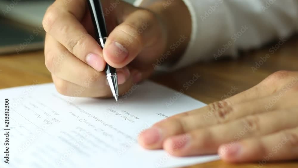 Businessman signing a document in office