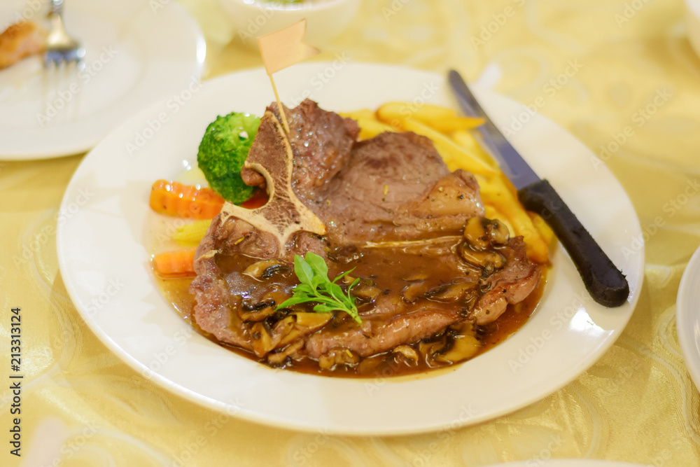Beef steak in the plate on the table of Soft Focus Beef steak in the plate on the table of Soft Focus