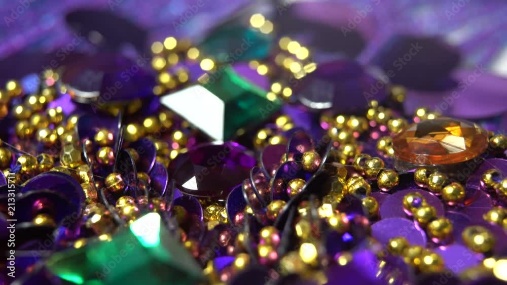 Extreme closeup of finger pressing a purple rhinestone into a puddle of hot glue. Extreme closeup of finger pressing a purple rhinestone into a puddle of hot glue.