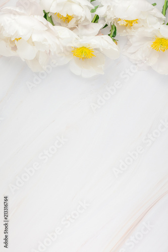 White peony flowers on marble background © dvoevnore