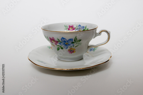 An isolated porcelain cup in a saucer