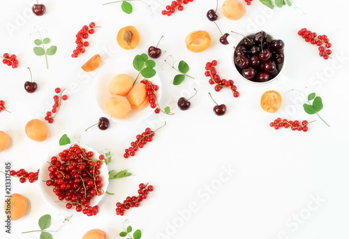 Summer yummy fruits  berry background  food colors pattern  from apricots  cherries  red currant  on a white background. Flat lay. Top view. Copy space