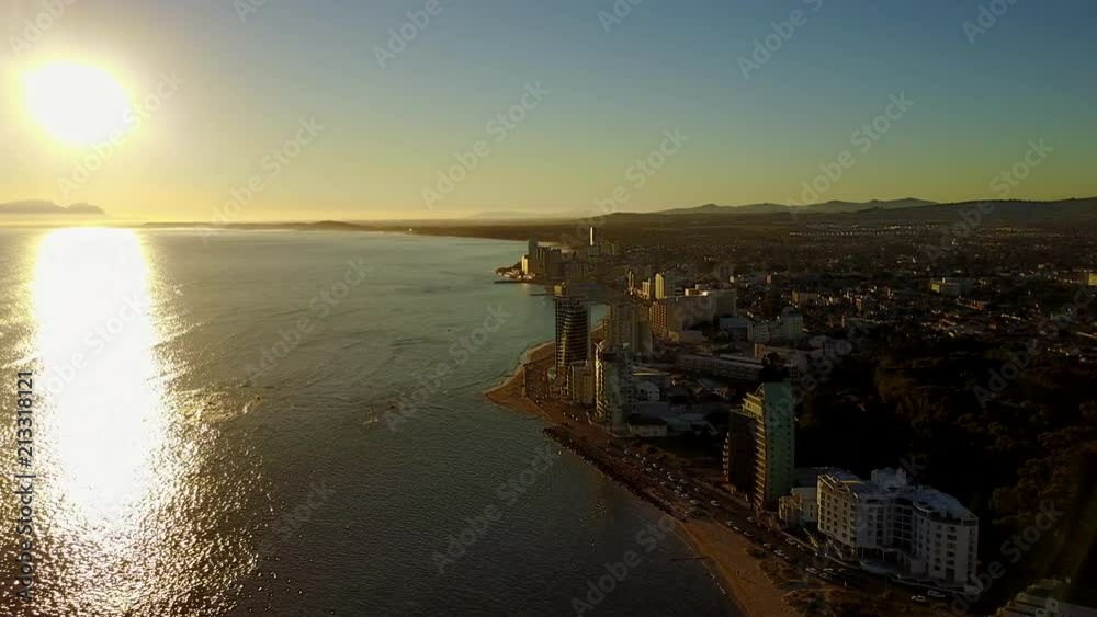 Flying over the coast at sunset at Strand in False Bay, South Africa. The City Skyline can be seen. Flying over the coast at sunset at Strand in False Bay, South Africa. The City Skyline can be seen.