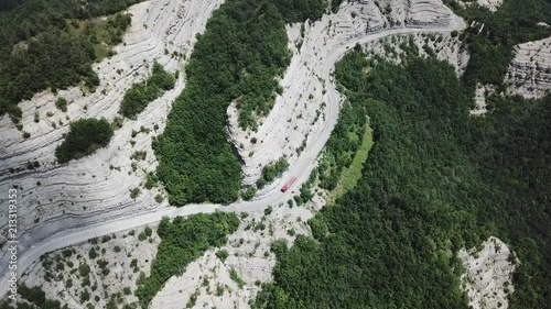 Italy. Scenic route to Mandrioli mountain pass. Vertical view of bends and a lorry. View of walls made of sandstone and marl screeds named Scalacce photo