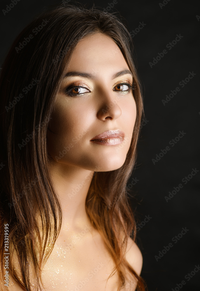 Close-up portrait of young woman with golden makeup. Close-up portrait of young woman with golden makeup.