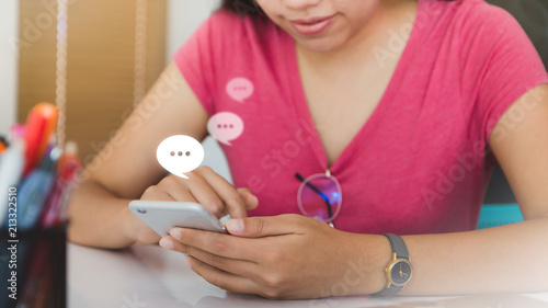 Woman using smartphone with Live Chat Chatting on white table in office space.Concept of business people use technology.
